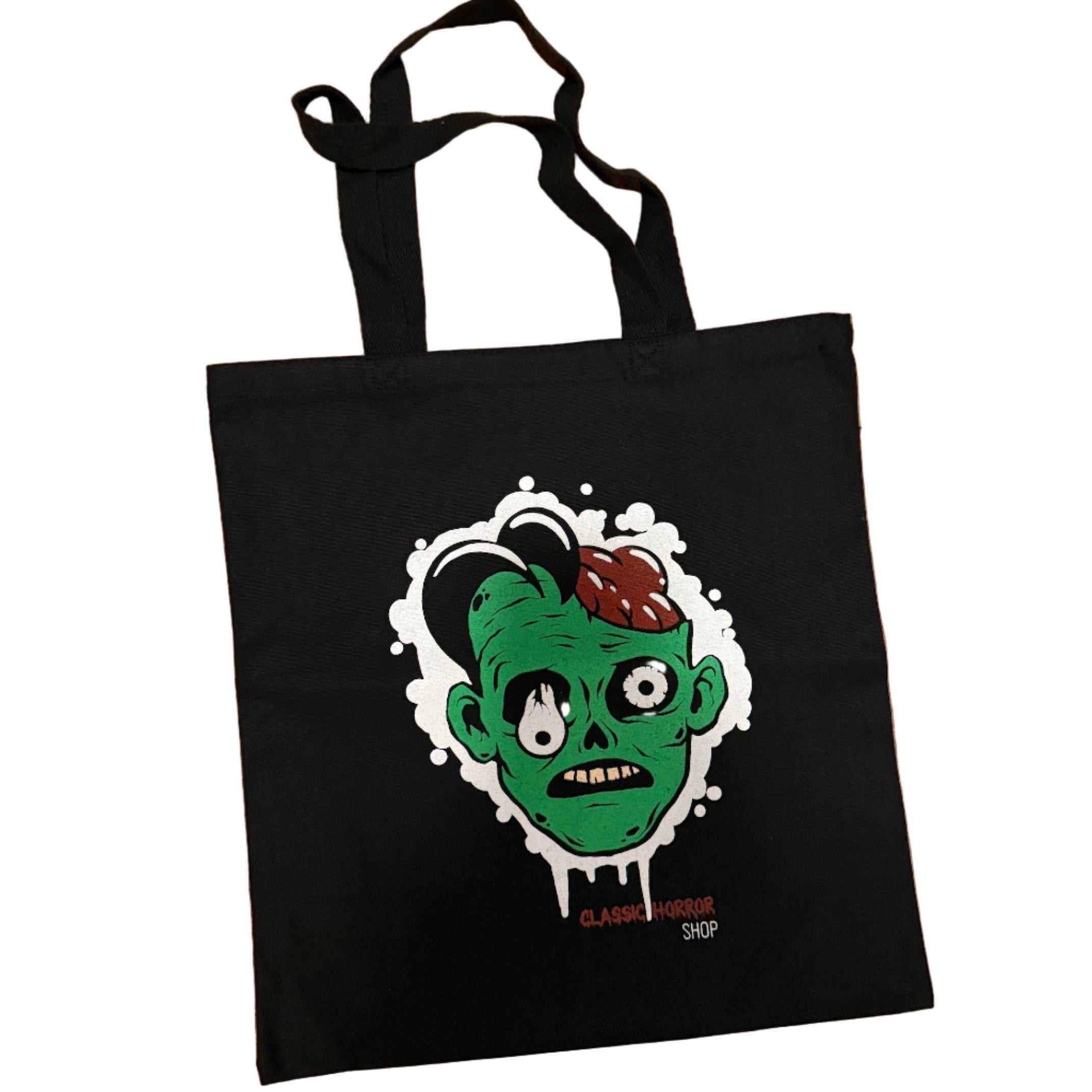 Black tote bag with a graphic design of a zombie head on a cork background