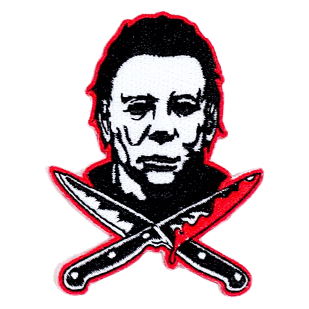 This is a Halloween Michael Myers back patch that has a white face, dark hair and two bloody knives, that are crossed.