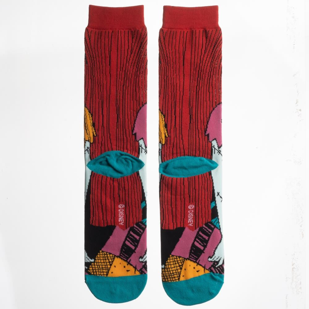 This is a pair of Nightmare Before Christmas Sally 360 crew socks and she has red hair and stitched arms.