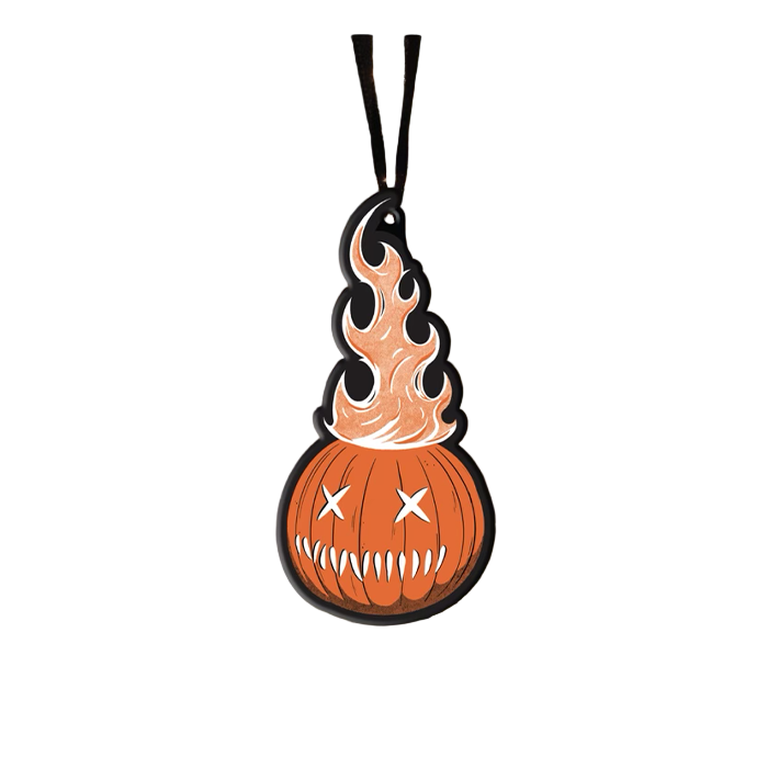 This is a Trick 'R Treat Same bitten lollipop metal ornament that is hanging from a black ribbon and has an orange pumpkin, with x eyes and fire coming out of it.