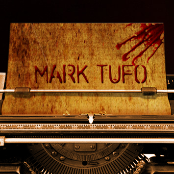 Typewriter with the name Mark Tufo on the piece of paper in it