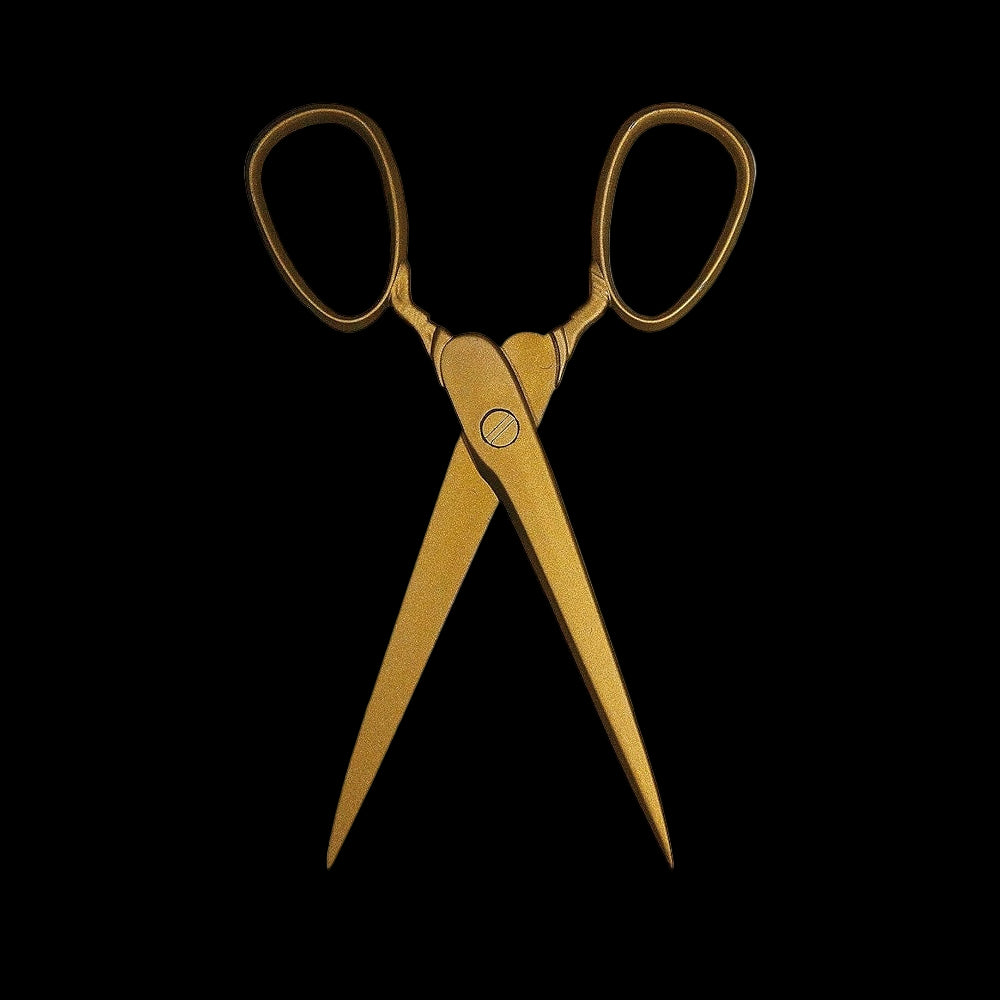 Gold scissors on a white background