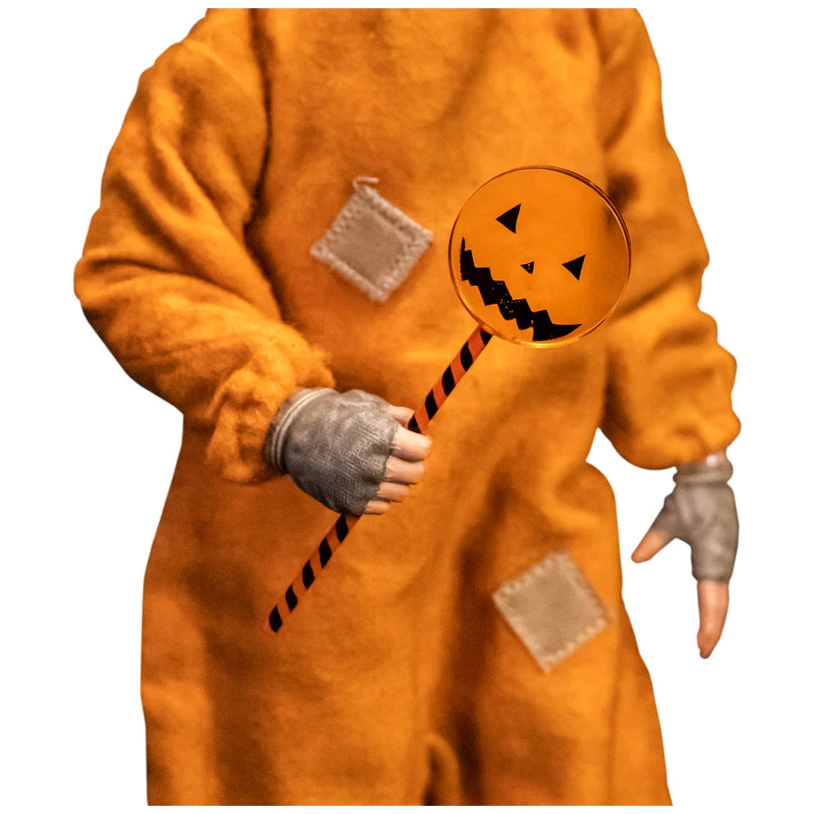 This is a Trick 'T Treat Sam 1:6 scale Figure and he has an orange jumpsuit with patches and an orange pumpkin lollipop