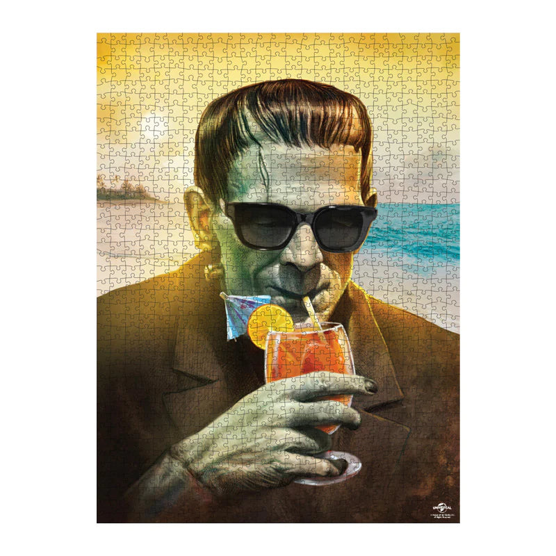 This is a Universal Monsters Frankenstein with beach and tropical drink puzzle and he has a green face, sunglasses, brown suit and dark hair 
