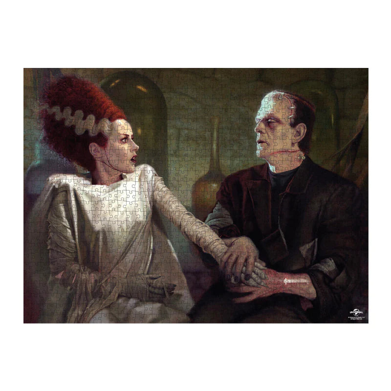This is a Universal Monsters Frankenstein with Bride puzzle and he has a green face, brown suit and staples in his head and she has dark hair with white stripes and a white dress 