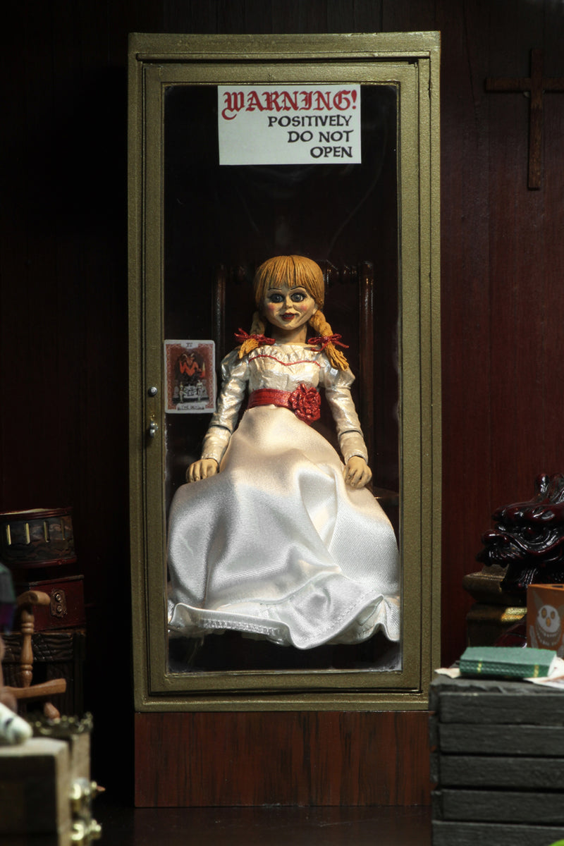 Annabelle NECA from the Conjuring is sitting in a glass display case on a rocking chair and has 2 heads.