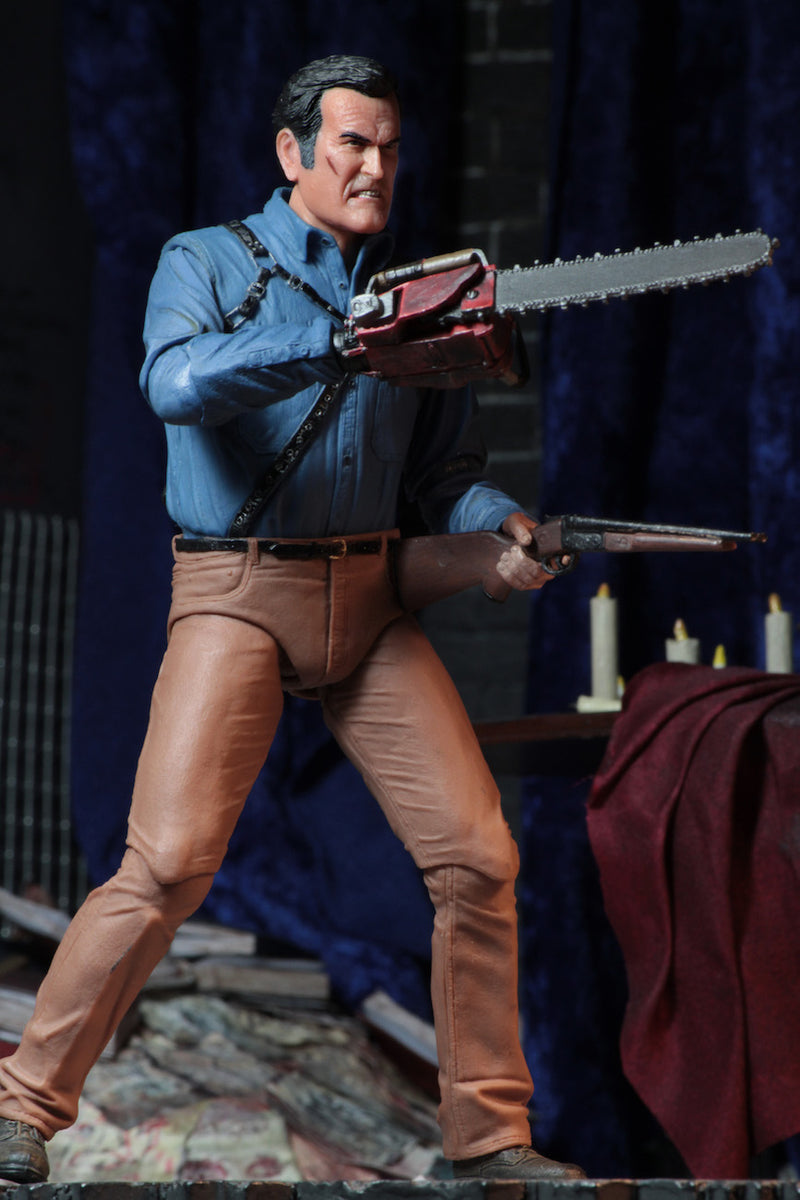 This is an Ash vs Evil Dead 7" Intimate NECA action figure with blue shirt, tan pants and he is holding a chainsaw and shotgun.