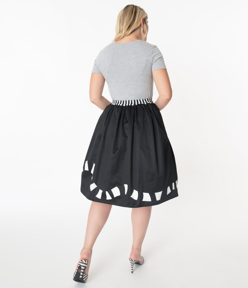 This is a Beetlejuice vintage pinup Sandworm swing skirt from Unique Vintage, that is black with a striped worm and the model is wearing a grey shirt and black and white striped shoes, with her hair to the side.