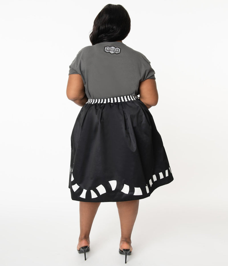 This is a Beetlejuice vintage pinup Sandworm swing skirt from Unique Vintage, that is black with a striped worm and the plus model is wearing a grey shirt and black shoes, with her hair to the side.