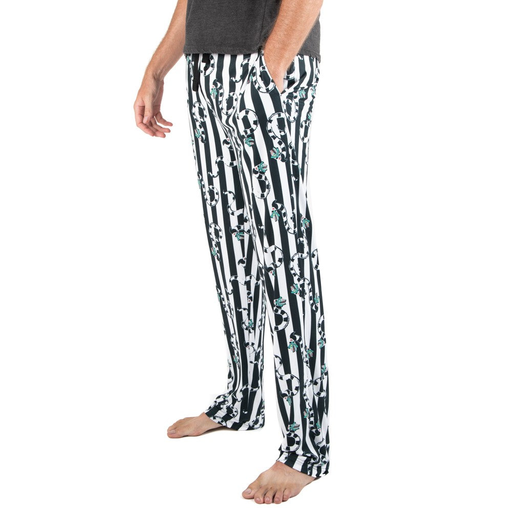 This is a Beetlejuice Sandworm sleep pant pajamas and they are black and white striped, with striped worms with green heads and it has pockets.