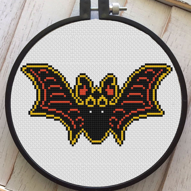 This is a vintage style Halloween black bat cross stitch kit and he has yellow and orange accent colors.