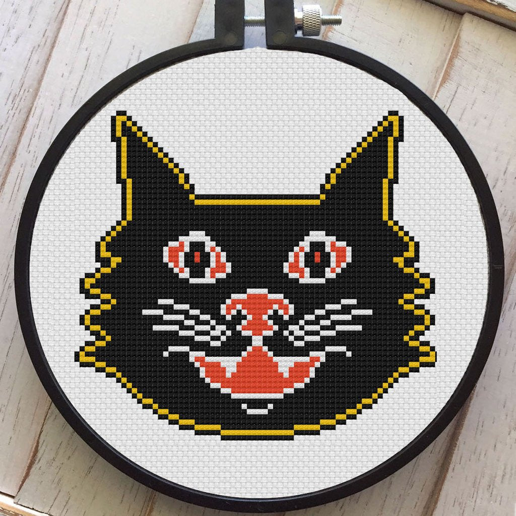 This is a DIY cross stitch kit and it is a vintage style black cat, with yellow and orange accent colors.