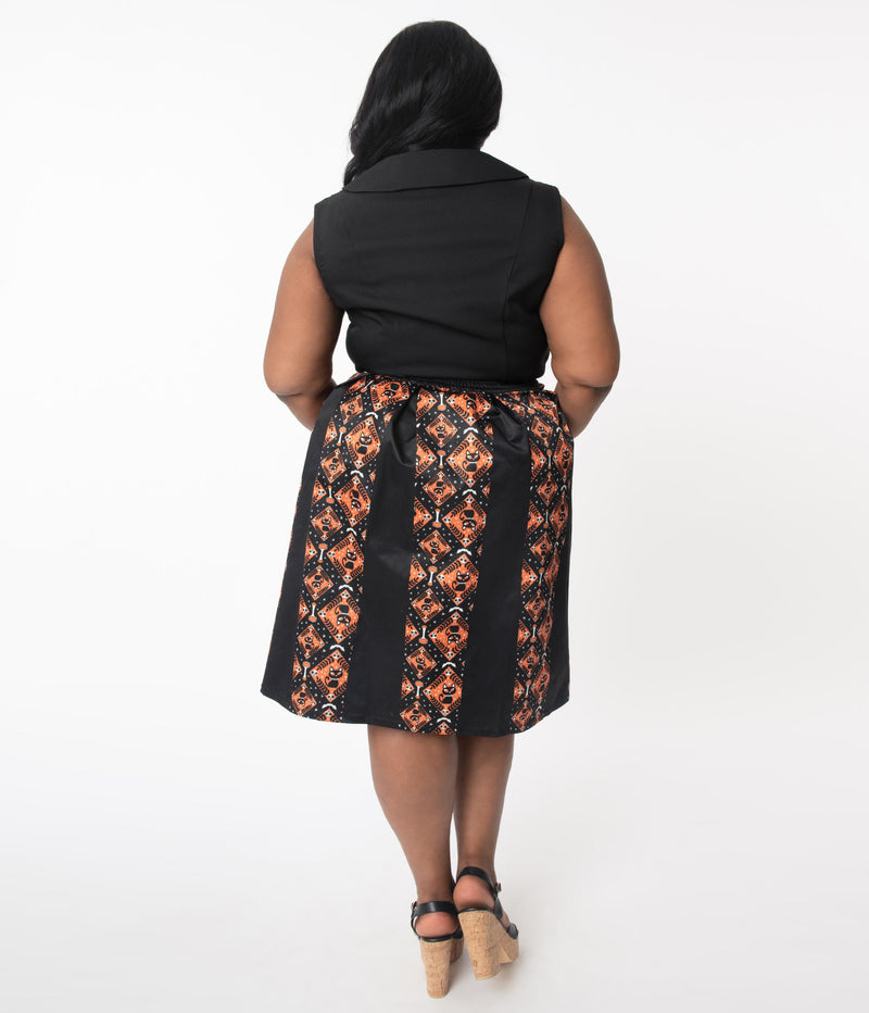 This is the back of a Unique Vintage Halloween swing skirt that has black cats, bats and skulls with orange print and the model is wearing a plus sized black shirt.