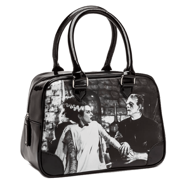 This is a black and white universal monsters Bride of Frankenstein bowler handbag purse and has Frankenstein holding her hand.