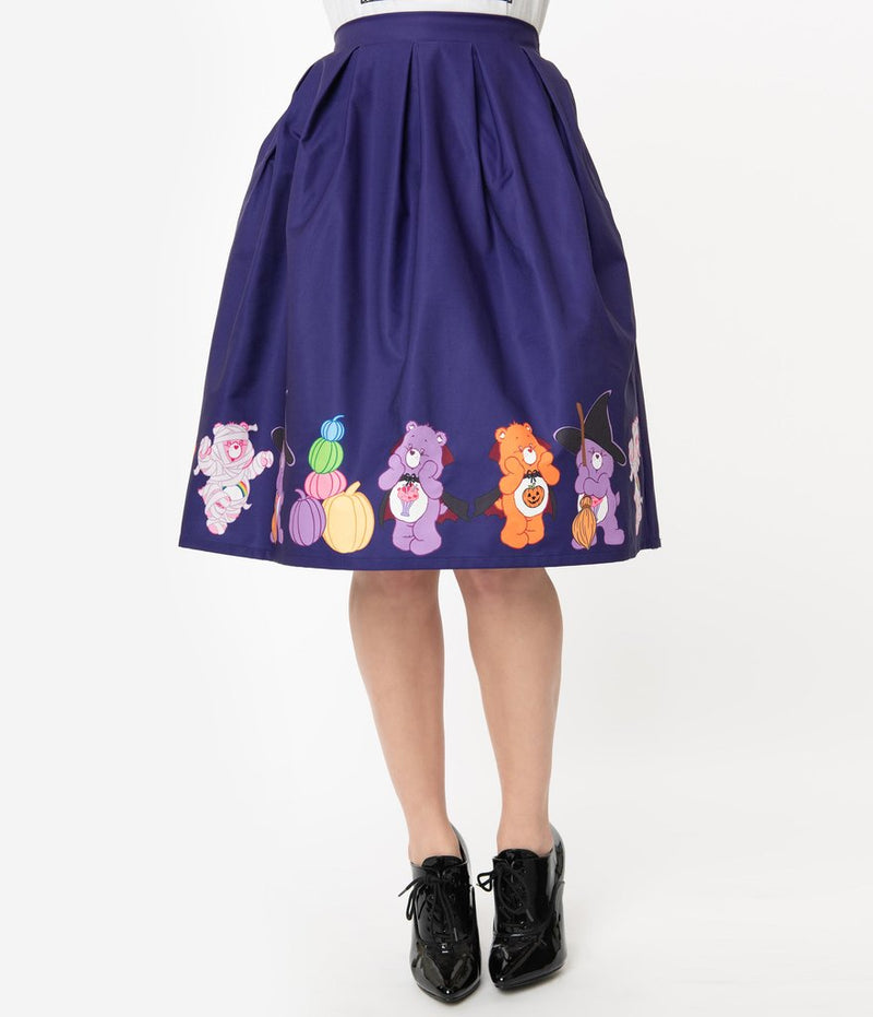 This is a Care Bears halloween purple Jayne swing skirt by Unique Vintage, with pumpkins, witch hats and brooms and the model has on black shoes.