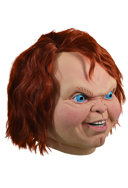 This mask is of Chucky from Child's Play 2 and he has bright blue eyes, orange hair and a butt chin and he is turned to the side.