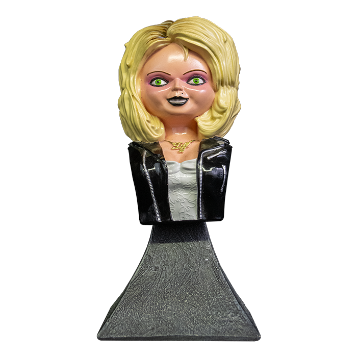 This is a Bride of Chucky Tiffany mini bust and she has blonde hair, a gold necklace, a black leather jacket with zippers, a white dress and a grey stand.