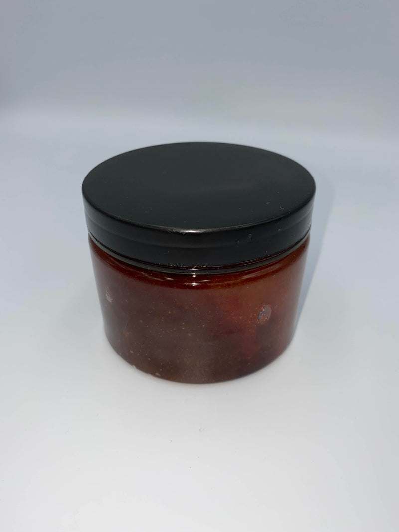 This is a red, blood like hemp sugar body scrub in a clear jar, with a black lid.