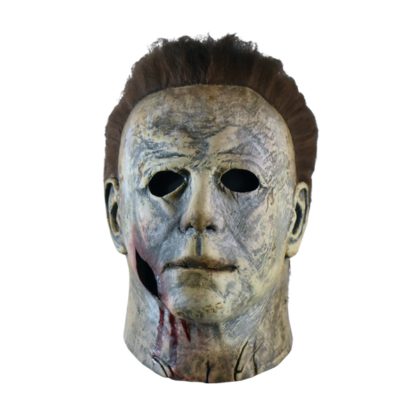 This is a weathered Michael Myers mask bloody edition from Halloween 2018 and it is grey and brown with brown hair and black eyes.