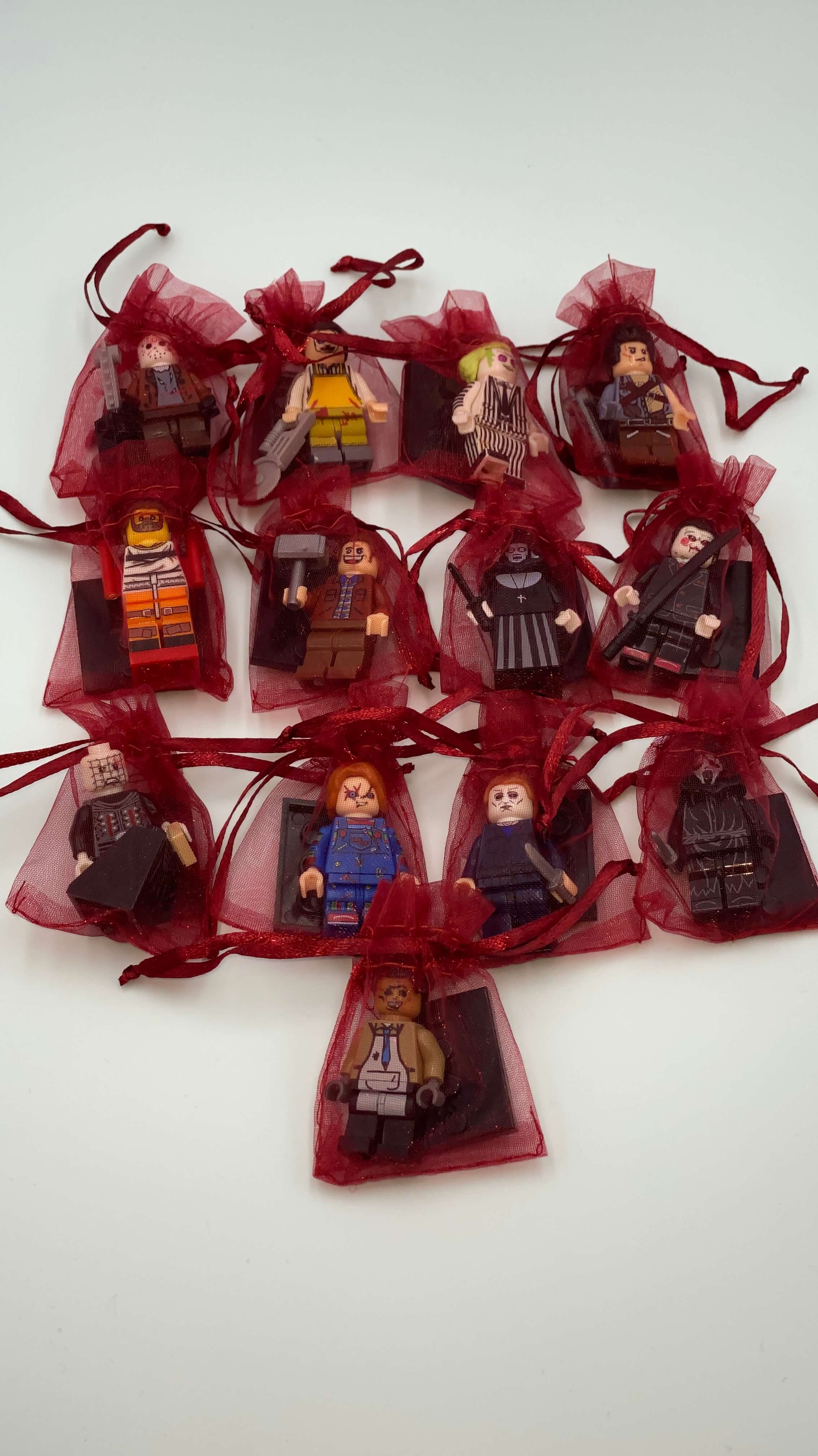 These are LEGO mini figures of horror characters: Leatherface, Jason Voorhees, Beetlejuice, Ash, Hannibal, Jack Torrance, Nun, Billy, Pinhead, Chucky, Michael Myers and Ghostface.