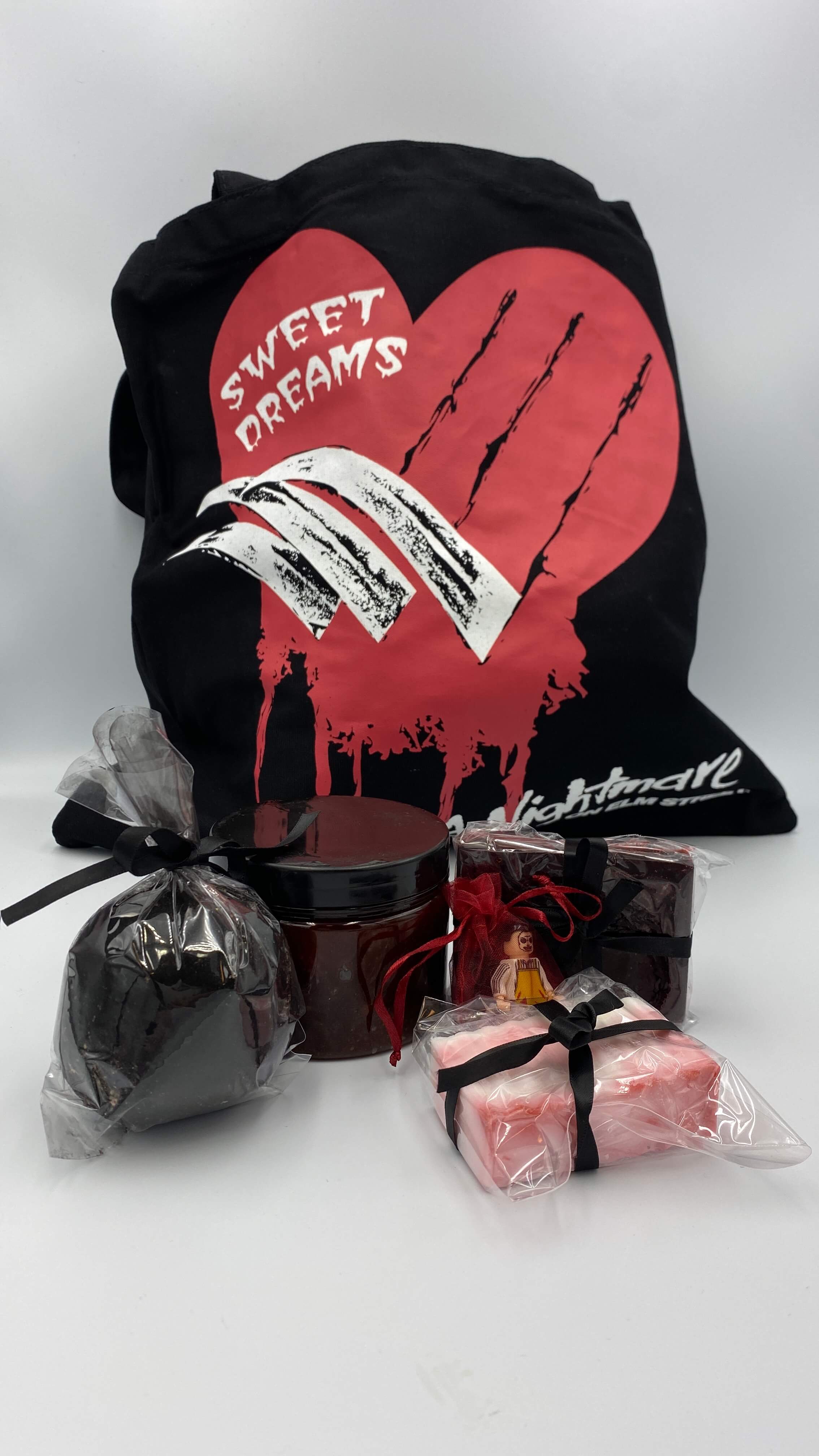 This is a bath and body set with a Nightmare On Elm Street tote that has knife fingers, a bloody red scrub, red soap, white soap, black charcoal hemp bath bomb and a LEGO mini figure.