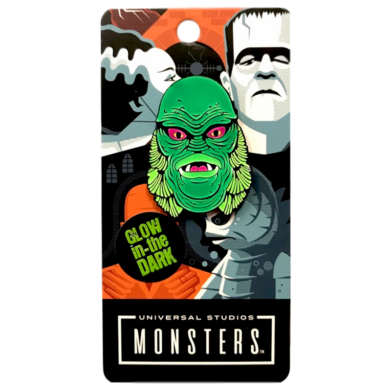 This is a Universal Monsters Creature From the Black Lagoon enamel pin that is a green face with red eyes, fins and two white teeth.