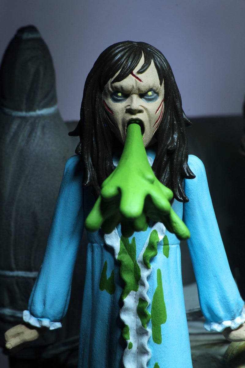 This is the Toony Terrors NECA action figure series 4 Regan from The Exorcist and she has a blue nightgown and she is vomiting green vomit and she has brown hair.