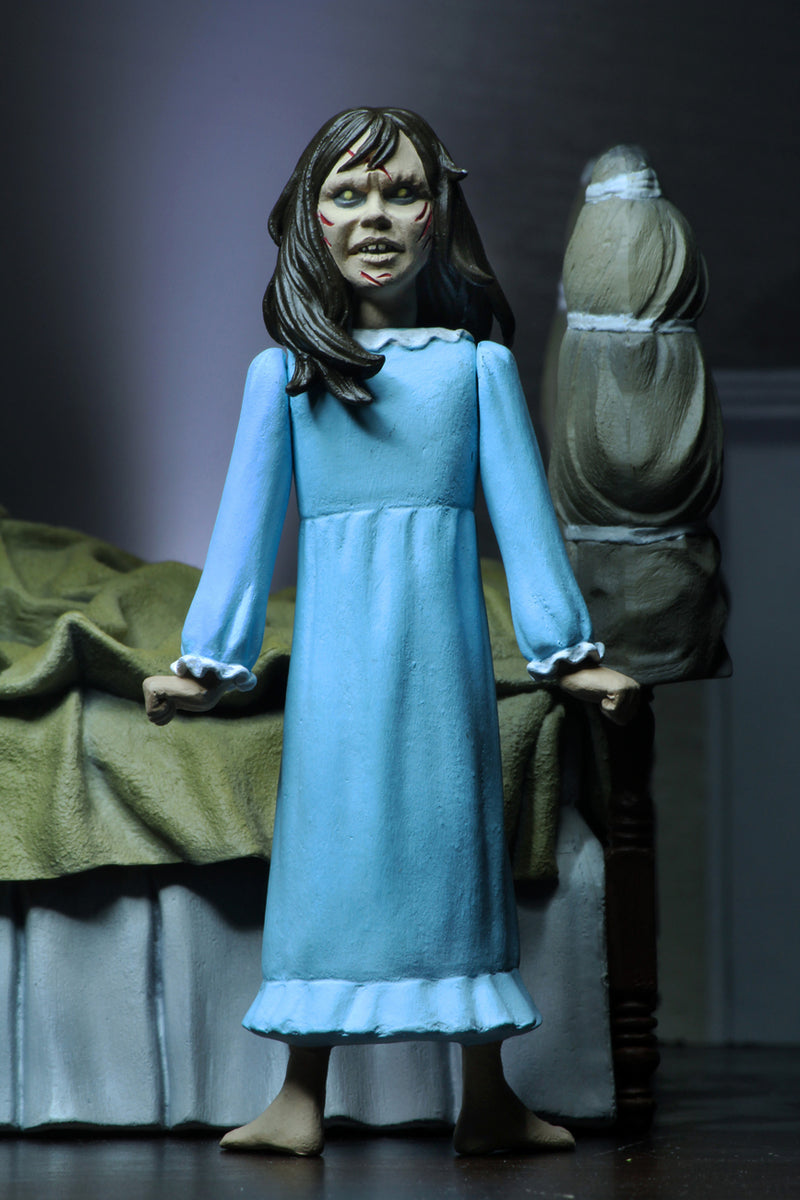 This is the Toony Terrors NECA action figure series 4 Regan from The Exorcist and she has a blue nightgown and she has brown hair and her head is backwards.