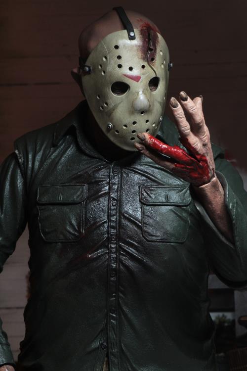 This is a NECA Jason Voorhees 1/4 scale action figure from Friday the 13th and he has a white hockey mask, green button up shirt and he is looking at his bloody, cut hand.