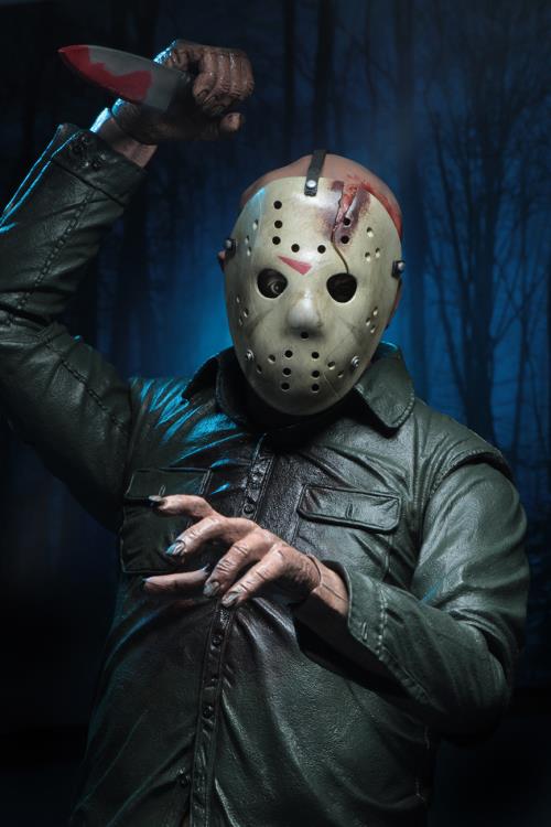 This is a NECA Jason Voorhees 1/4 scale action figure from Friday the 13th and he has a white hockey mask, green button up shirt, tan pants, bloody knife and he is in front of trees.