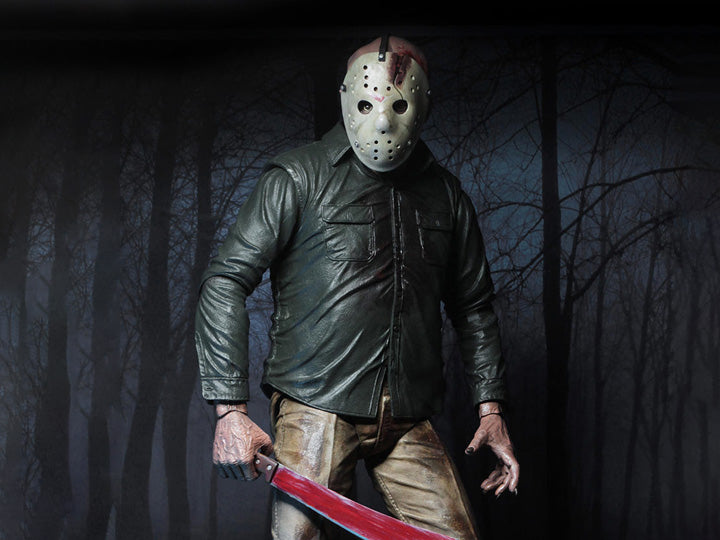 This is a NECA Jason Voorhees 1/4 scale action figure from Friday the 13th and he has a white hockey mask, green button up shirt, tan pants, bloody machete and he is in front of trees.