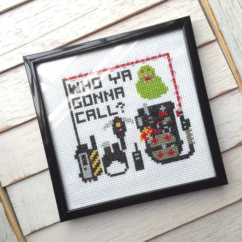 This is a Ghostbusters Slimer DIY cross stitch kit and he is green, there is a proton pack and ghost hunting tools.