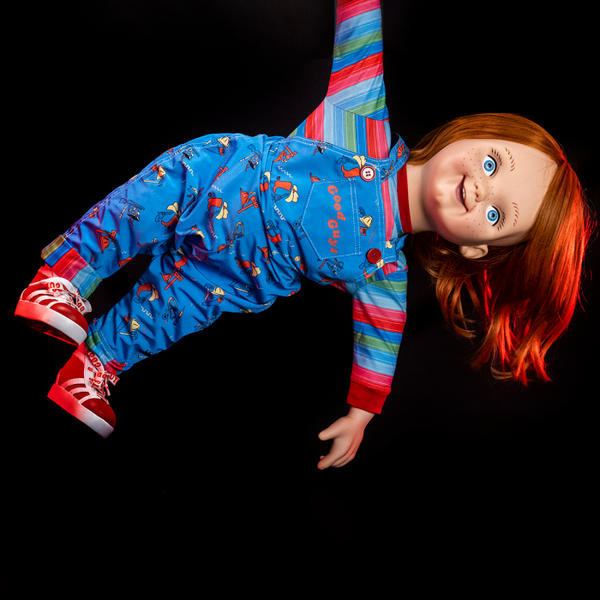 This is a Child's Play Chucky Good Guy doll and he his hanging down by his arm.