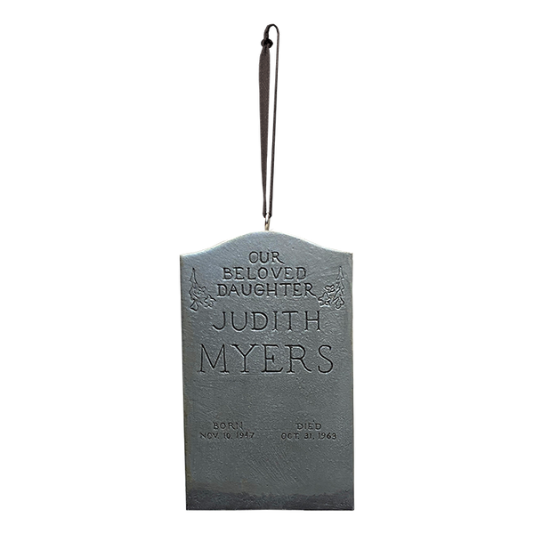 This is a 1978 Halloween Judith Myers Tombstone ornament that is grey and has a ribbon hanger.
