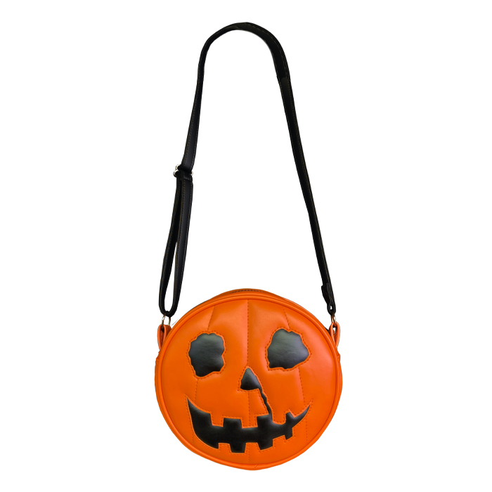 This is a Halloween 1978 pumpkin purse that is orange with a black strap and has black eyes, black nose and an orange smile.