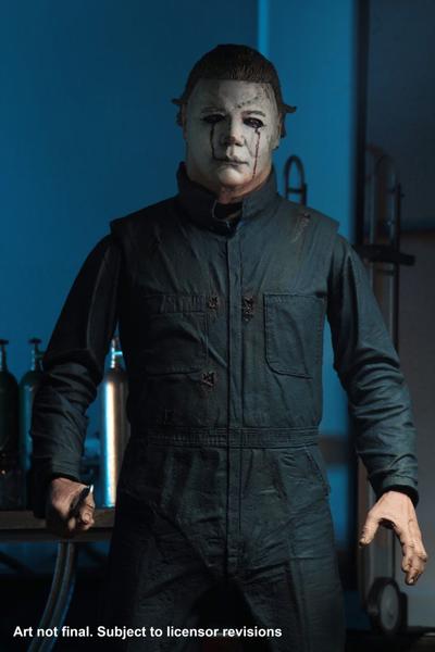 This is a Halloween II Michael Myers NECA action figure and he is wearing a white mask with dark blonde hair, with green blue coveralls..