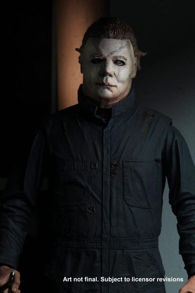 This is a Halloween II Michael Myers NECA action figure and he is wearing a white mask with green blue coveralls..
