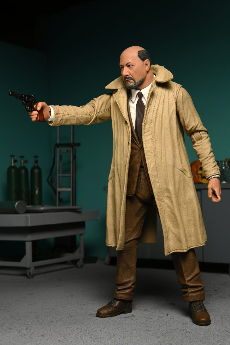 This is a NECA Halloween 2 Michael Myers and Loomis action figure set and Loomis has a tan coat, brown suit, brown tie, holding a gun and there is an orange pumpkin.