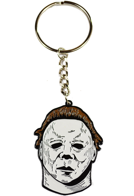 This is a Halloween II Michael Myers enamel Keychain that has a white face, brown hair and a silver chain with a hoop for keys.
