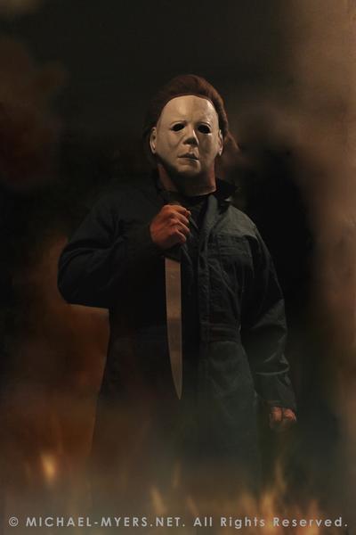 This is a Halloween II Michael Myers mask, that is a white face with brown hair and eye holes, a knife and green coveralls.