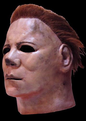 This is a Halloween II Michael Myers mask, that is a white face with brown hair and eye holes.