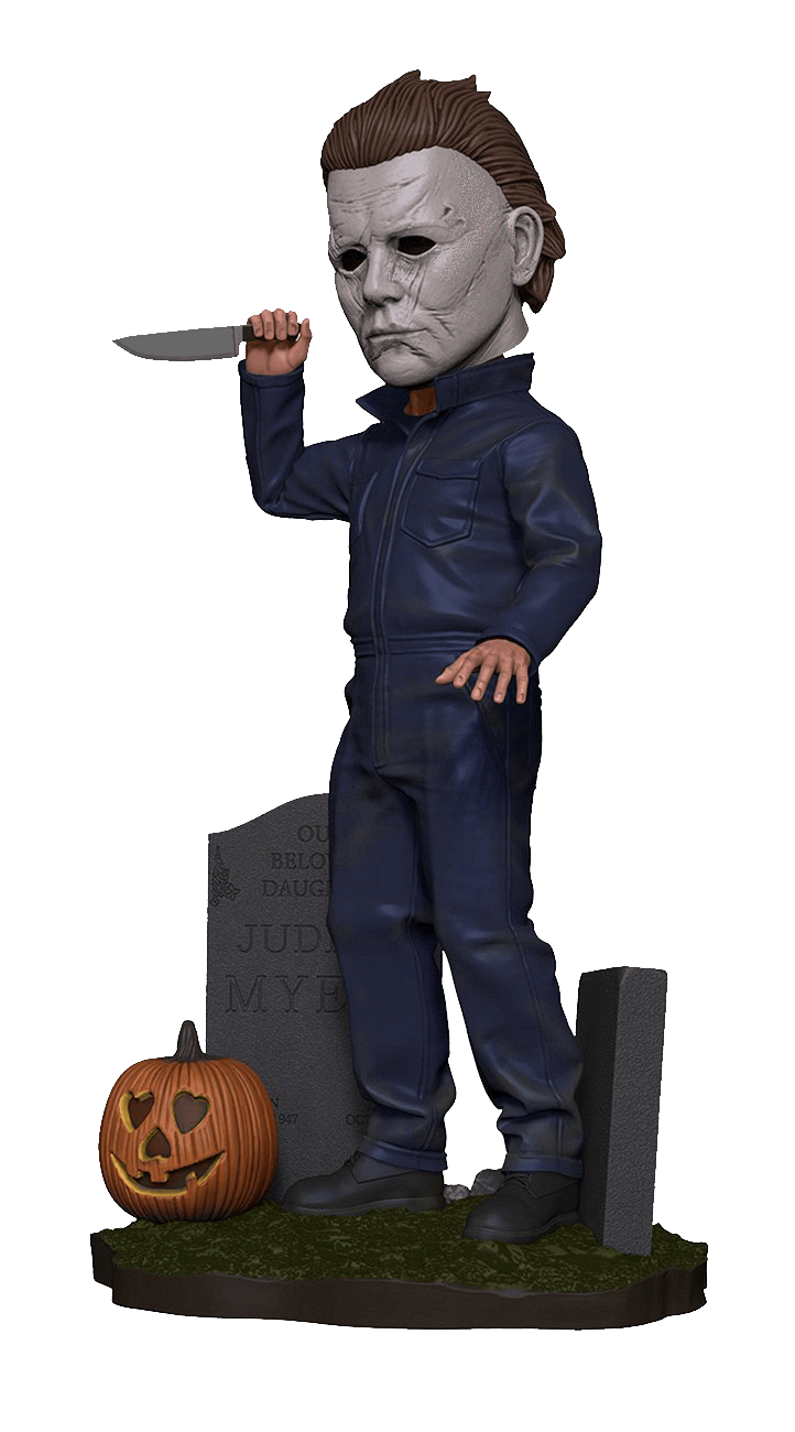 This is a 2018 Michael Myers NECA head knocker, where he is holding up a knife in his hand, has tombstones and a pumpkin around him and is wearing a white mask with brown hair and grey coveralls.