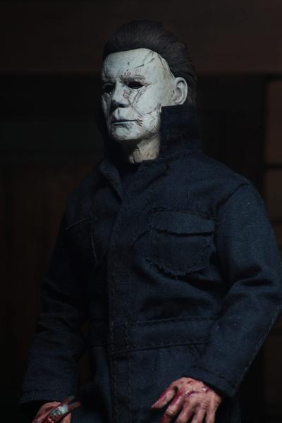 This is a NECA 8" clothed action figure from Halloween 2018 of Michael Myers, who is wearing a grey and weathered mask and grey coveralls.