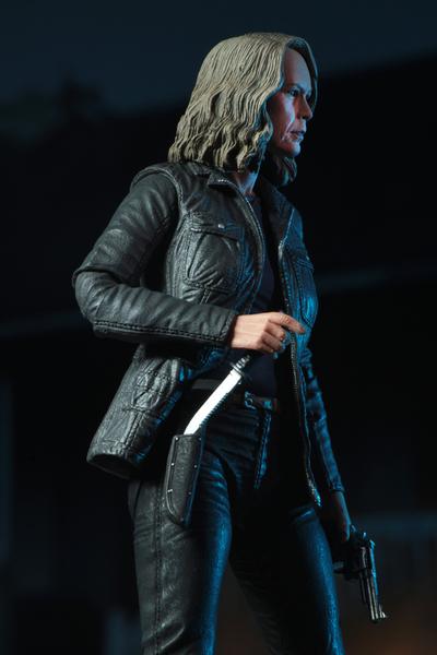 This is a HALLOWEEN 2018 NECA 7" Scale Action Figure Ultimate Laurie Strode and she has grey hair, glasses, a coat and a knife