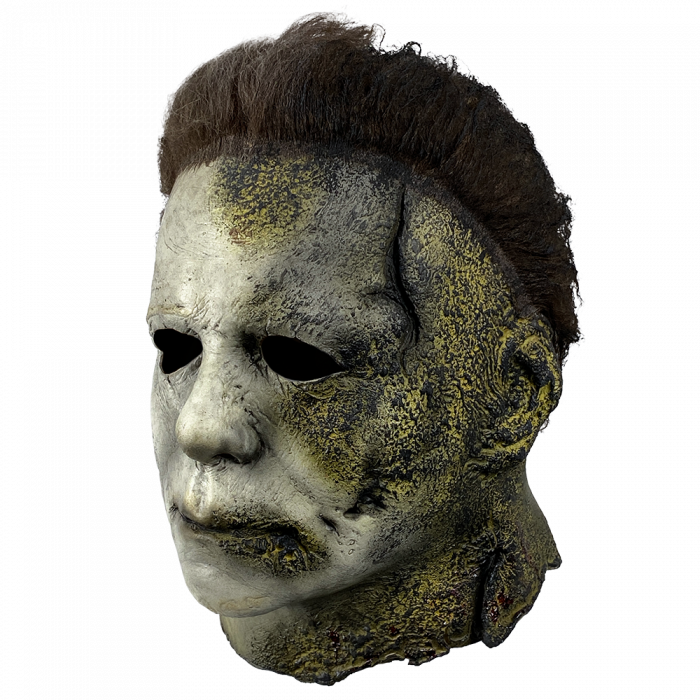 This is a Halloween Kills Michael Myers mask and he has a white face that has black burns and cuts and his brown hair is burnt.