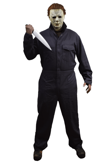 This is a man standing wearing a Michael Myers Halloween 2018 movie costume of grey coveralls, wearing a white mask with brown hair and holding a knife.