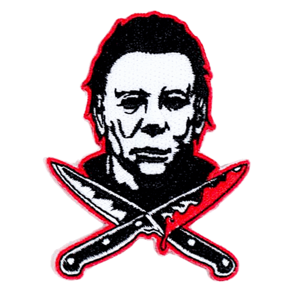 This is a Halloween Michael Myers back patch that has a white face, dark hair and two bloody knives, that are crossed.