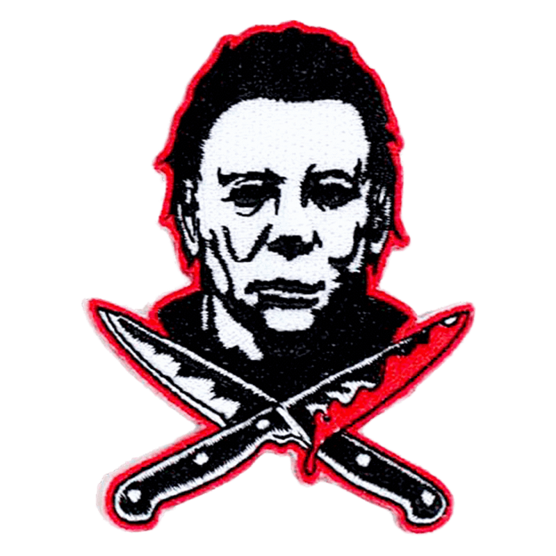 This is a Halloween Michael Myers back patch that has a white face, dark hair and two bloody knives, that are crossed.