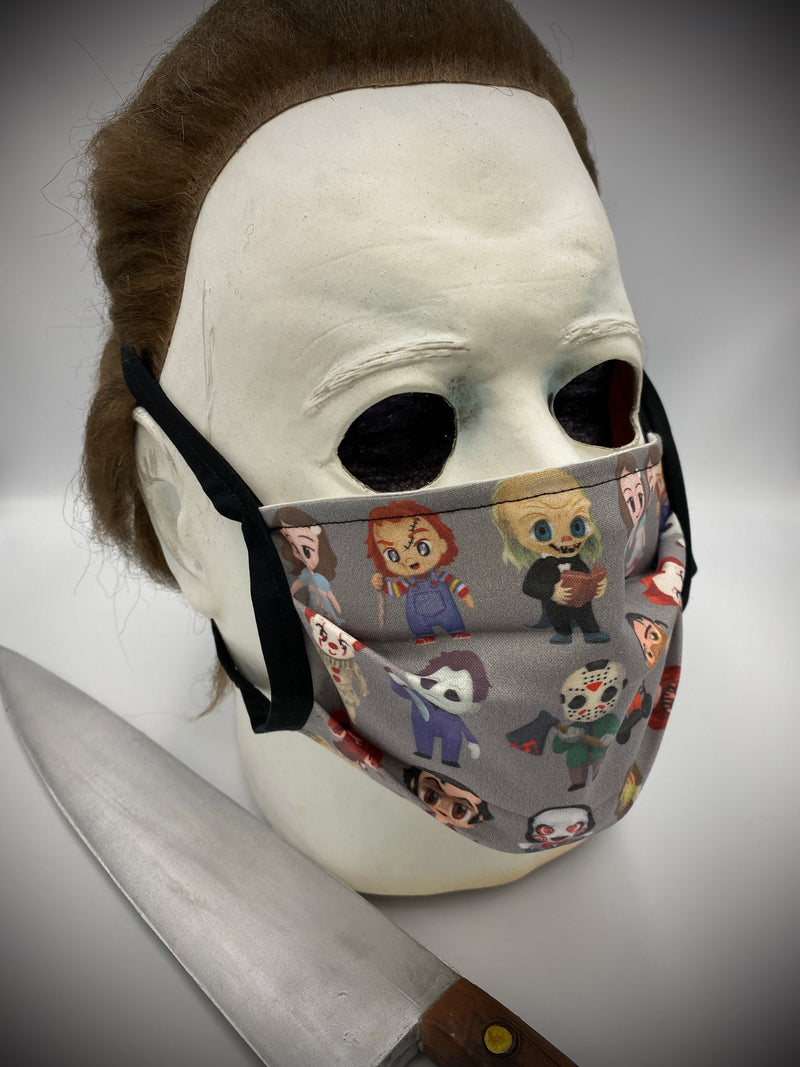 These are horror characters on a grey protective face mask with black ties and has the characters from Saw, Exorcist, Carrie, The Shining, It, Child's Play, Friday the 13th and Halloween.
