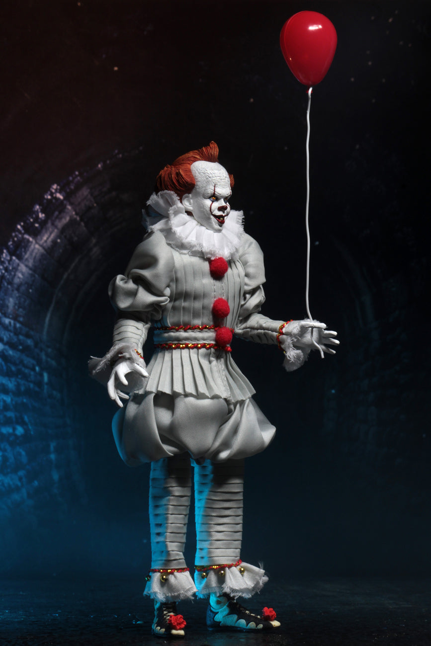 This is an It Movie 2017 Pennywise NECA action figure and he has orange hair, grey suit with red balls, white face, yellow eyes and white gloves
